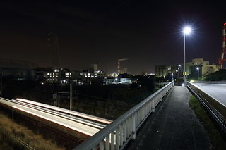歩道橋と電車の光跡夜景